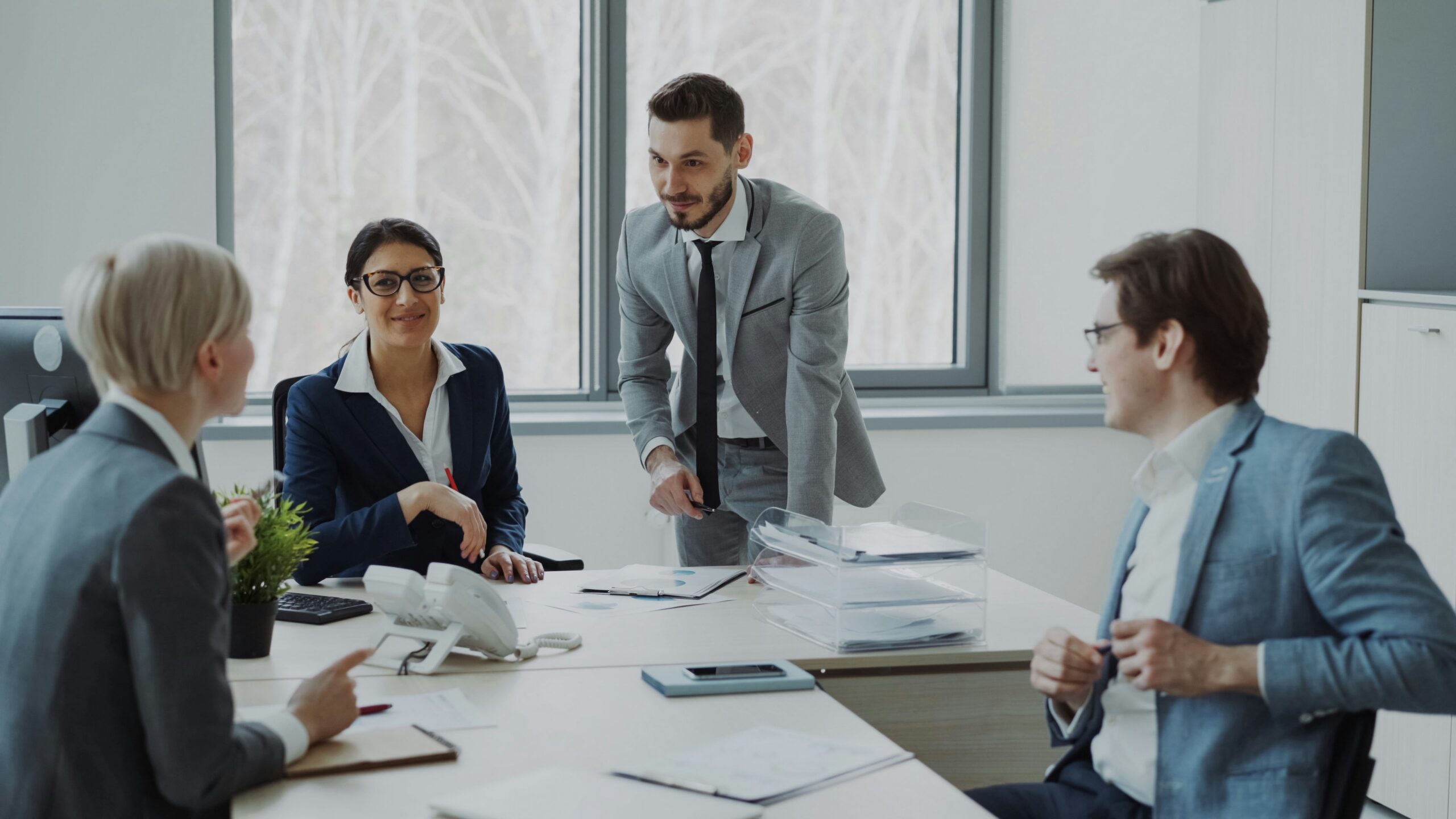 Business professionals collaborating around a conference table. Business professionals collaborating around a conference table.